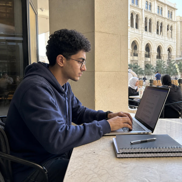 Student working on a laptop at a café in Cairo